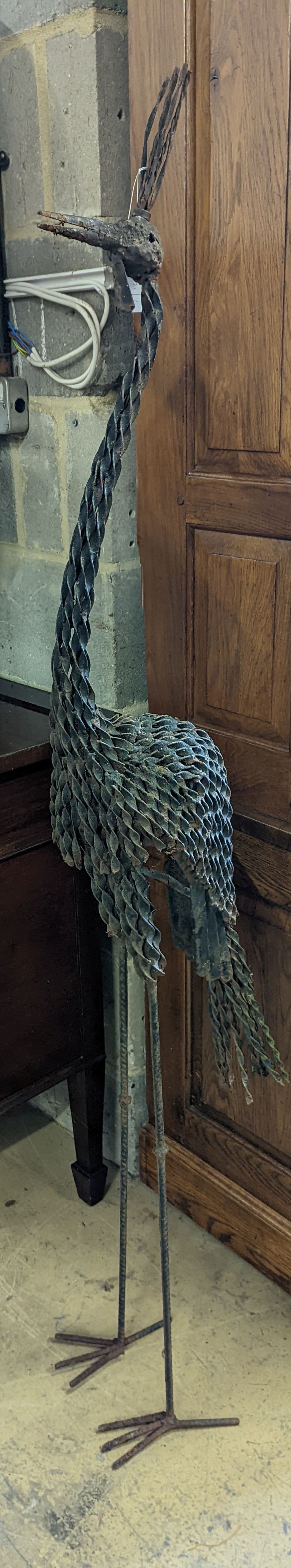 A wrought iron peacock garden ornament, height 170cm